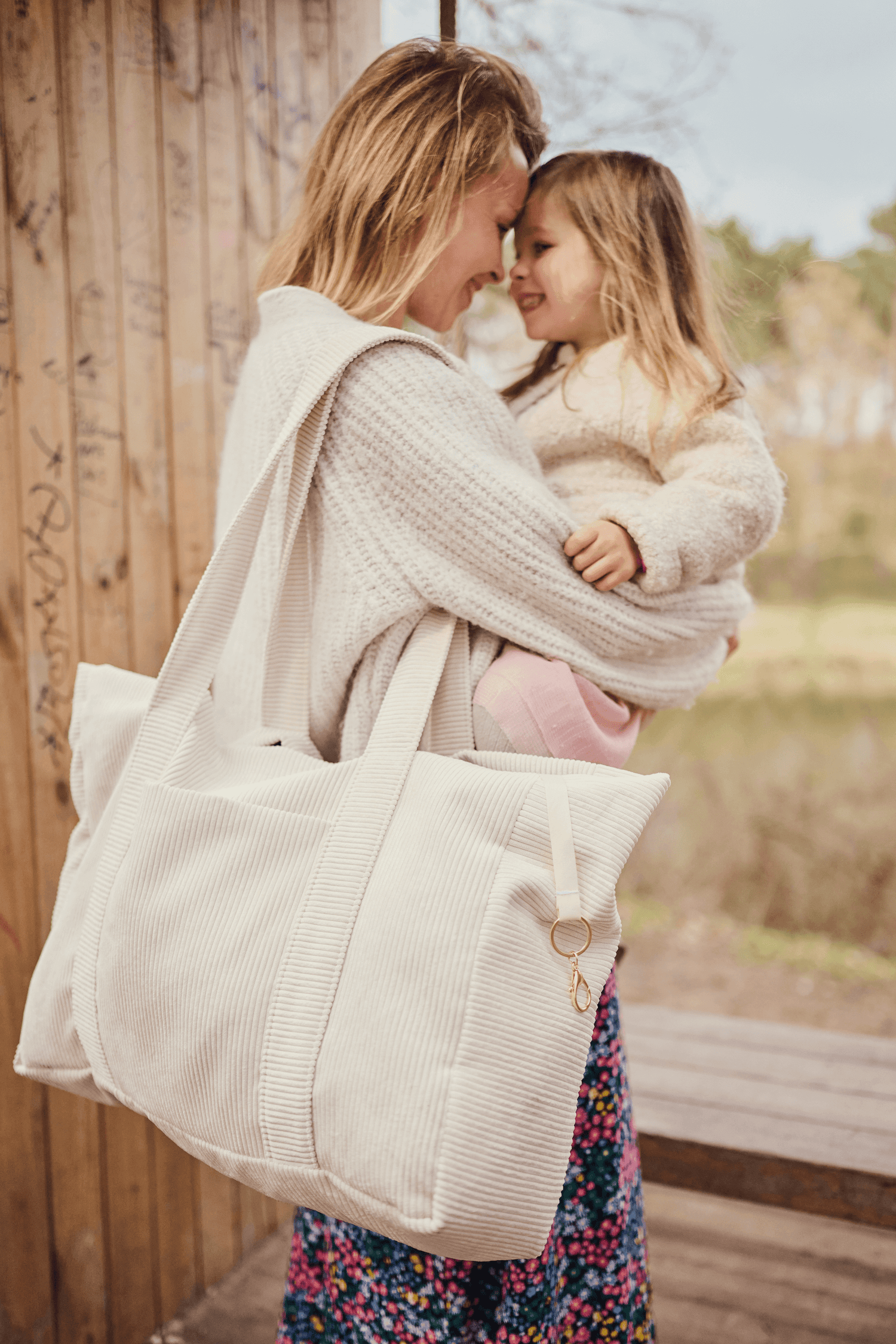 Young mom with daughter and corduroy shopper bag in cream colour. Tote bag by bettys home c