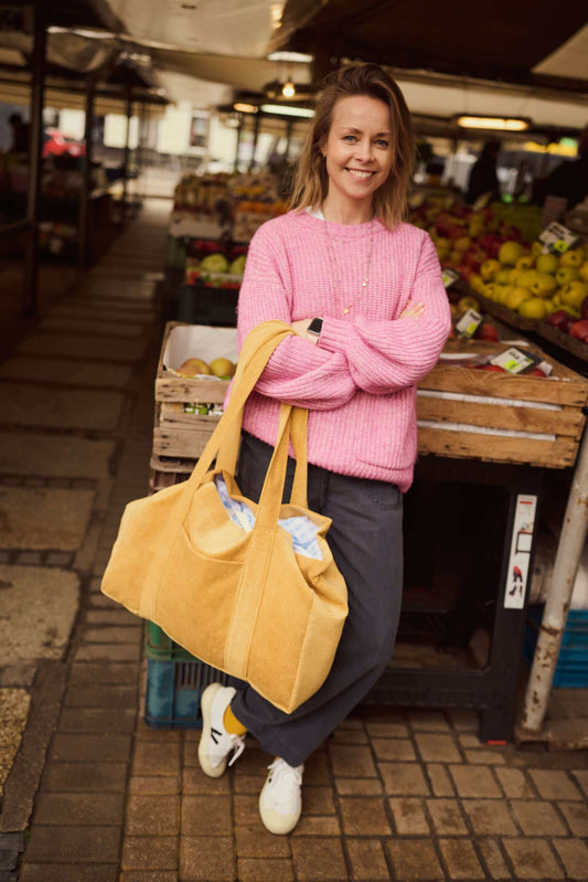 Woman with corduroy shopper bag in yellow. Mom bag. Tote bag