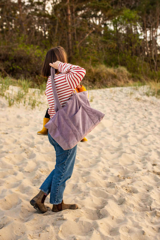 Corduroy Mom Bag in Lavender by Bettys Home.Young mom with her lavender tote bag on the beach