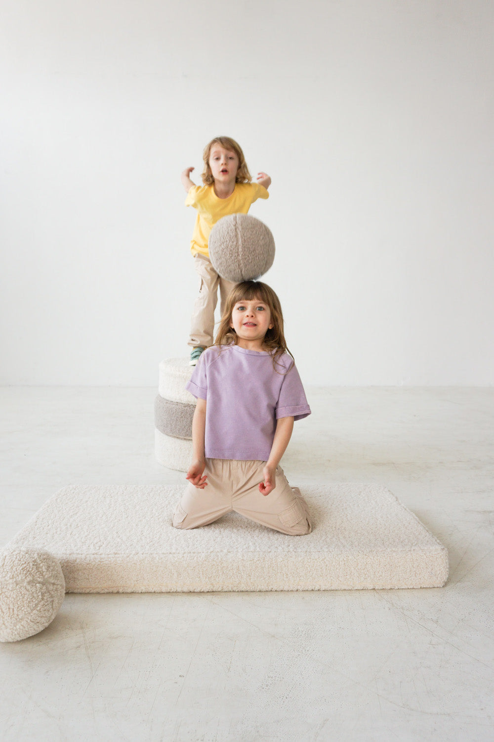 boy and girl playing boucle ball by bettys home on boucle mattress