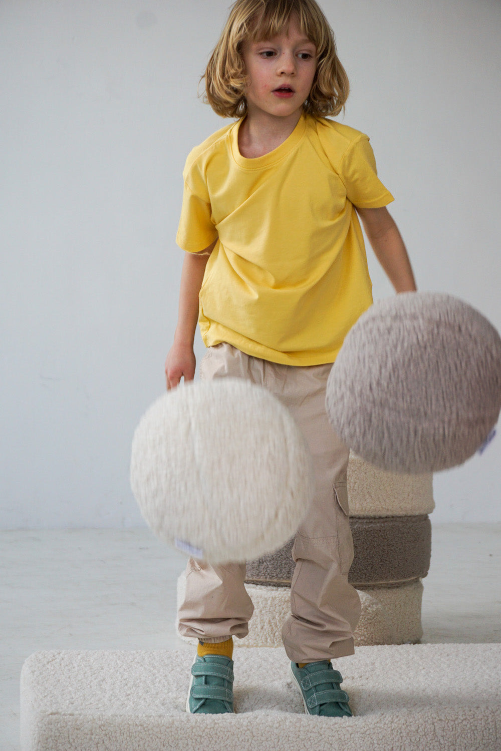 little boy playing with boucle ball cushion boy bettys home a
