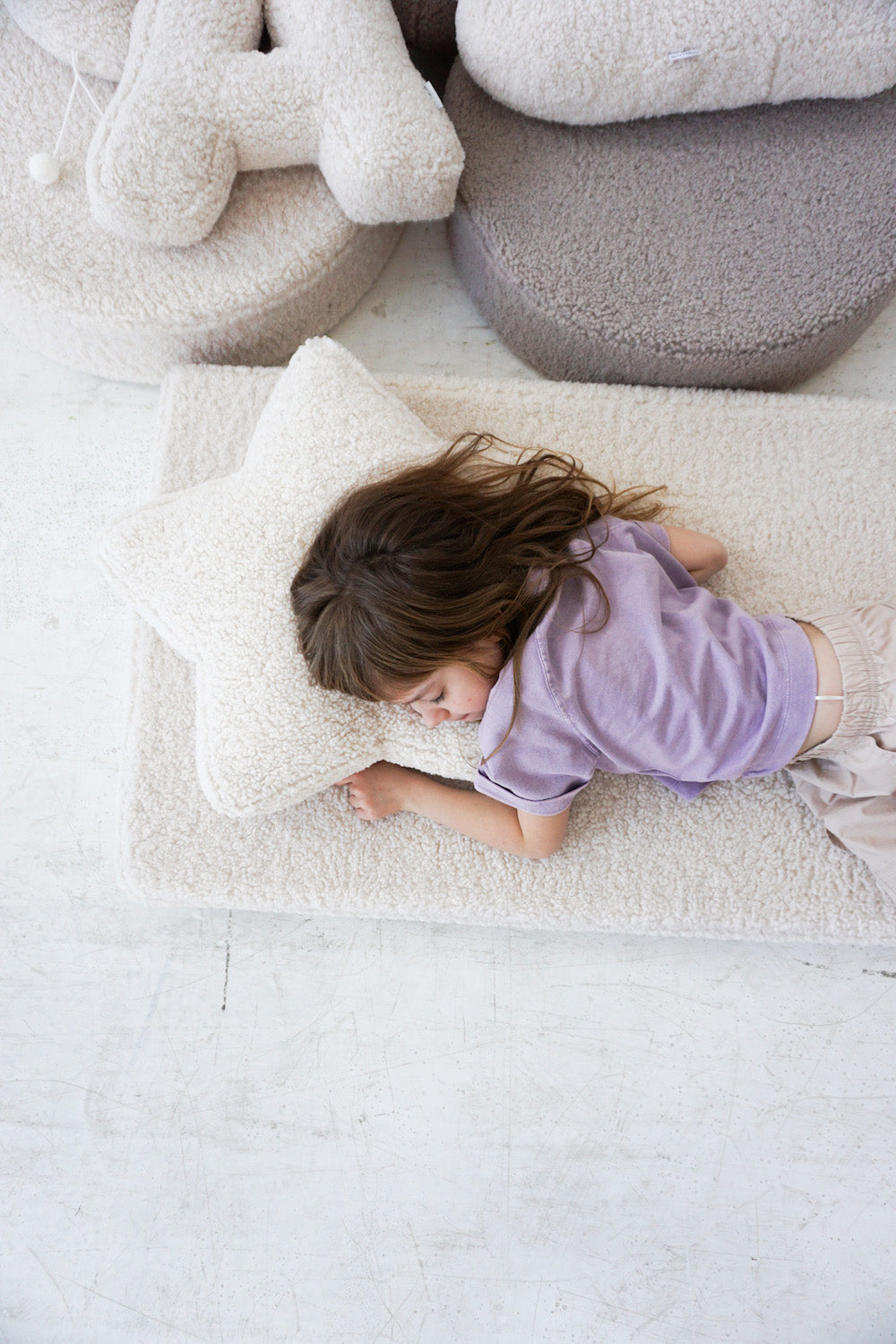 girl sleeping on boucle mattress with boucle star cushion boy bettys home under head