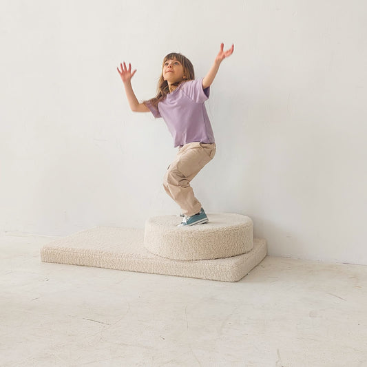 girl playing on boucle mattress and boucle pouf by bettys home 