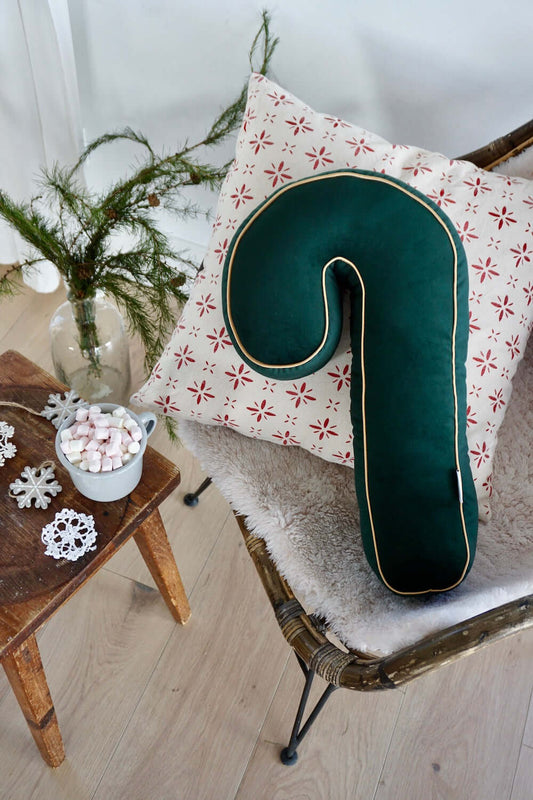 christmas candy cane cushion on chair as christmas living room decoration. christmas candy cane pillow green by bettys home