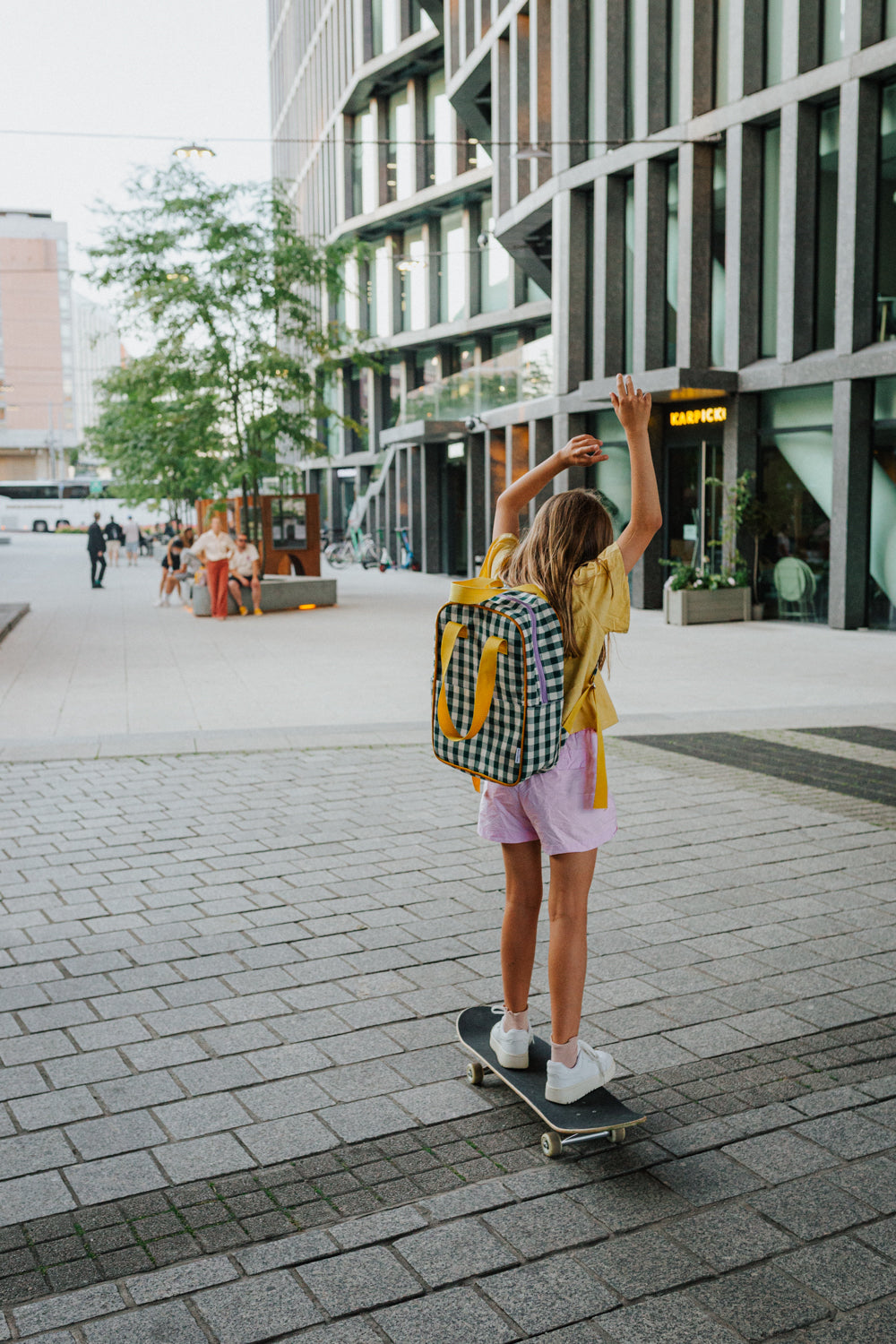 girl on skateboard with green gingham backpack. checkered backpack for kids  by bettys home