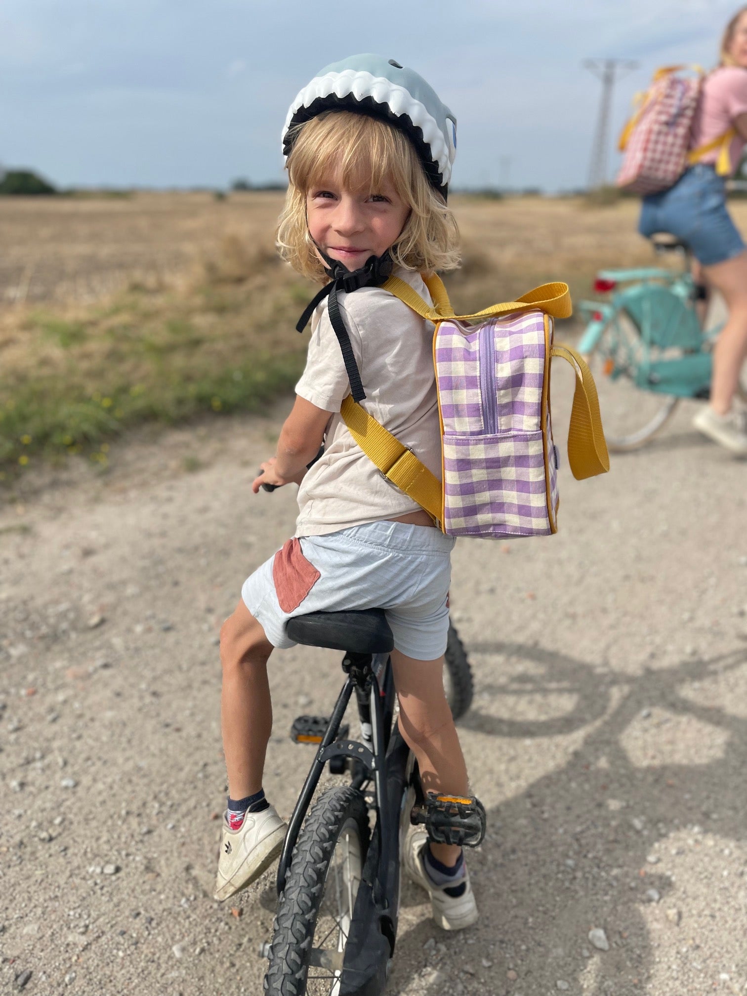 cute boy on bike with lilac gingham backpack. Small Checkered Backpack 