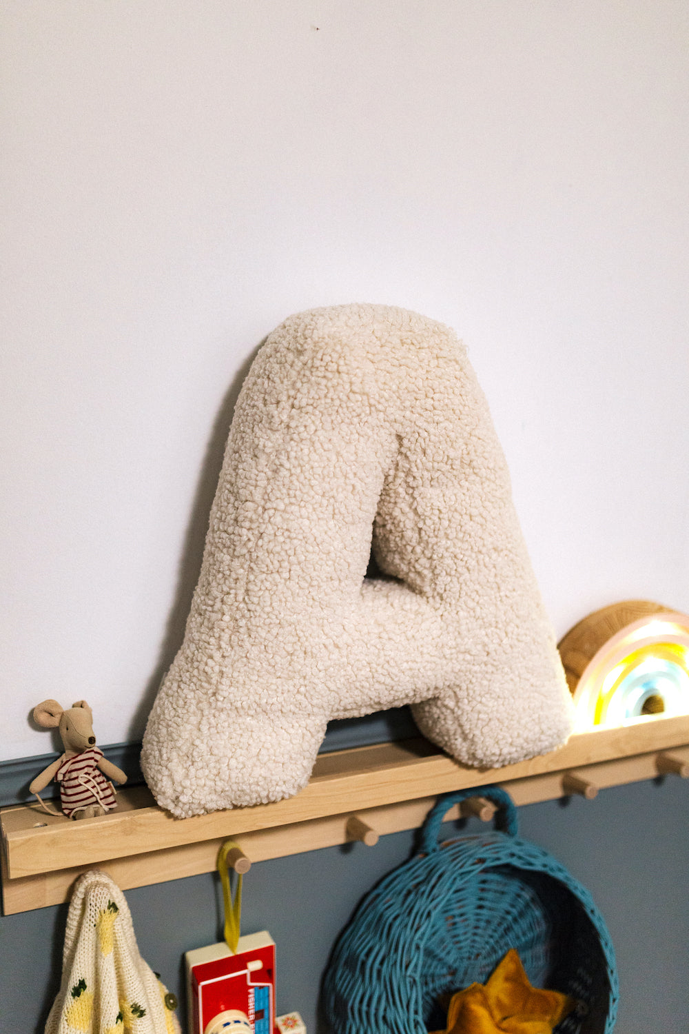 Boucle Letter cushion A by Bettys Home Teddy Letter Pillow on shelf in kids room as kids room decorations idea
