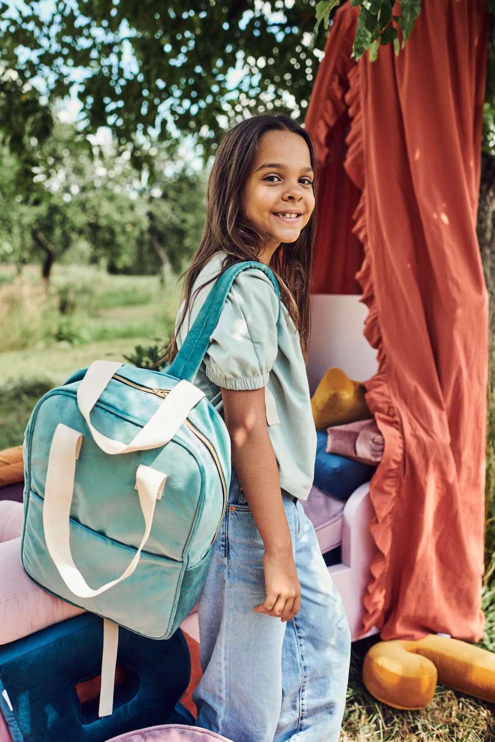 cute girl in garden with velvet backpack mint. middle school backpack. high school backpacks 
