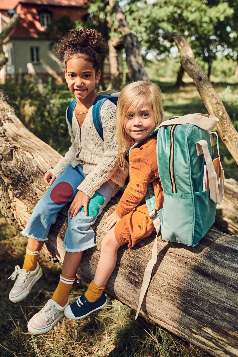 two cute girls sitting on tree after lesson with velvet backpack y bettys home. school backpack for girls 