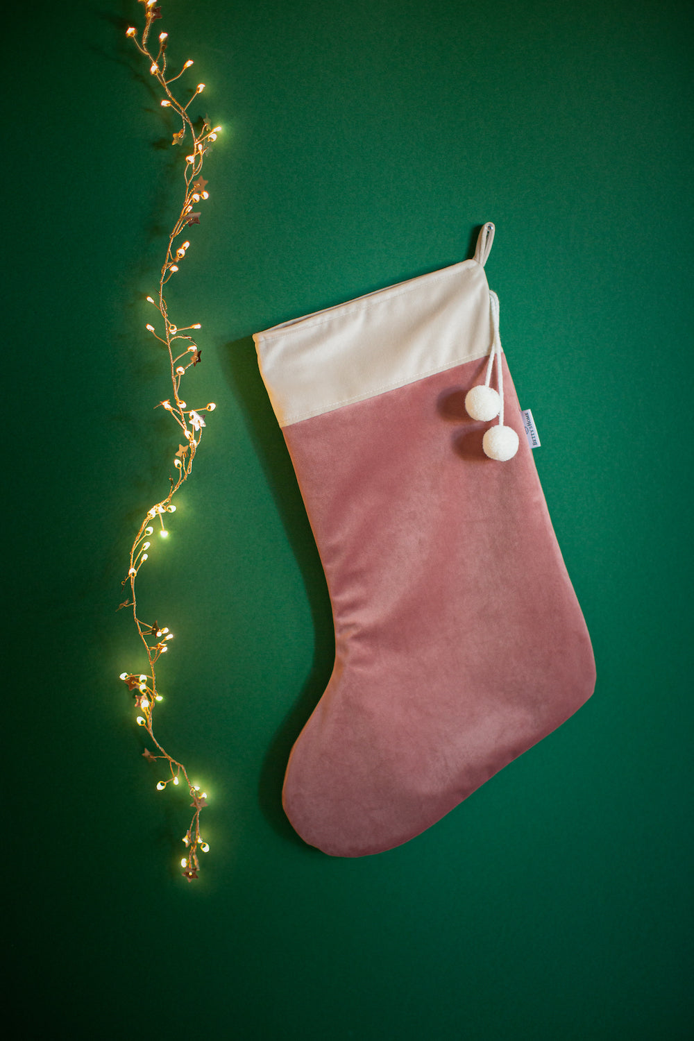 christmas stocking in pink velvet by Bettys Home on green wall. elegant christmas fireplace decorations