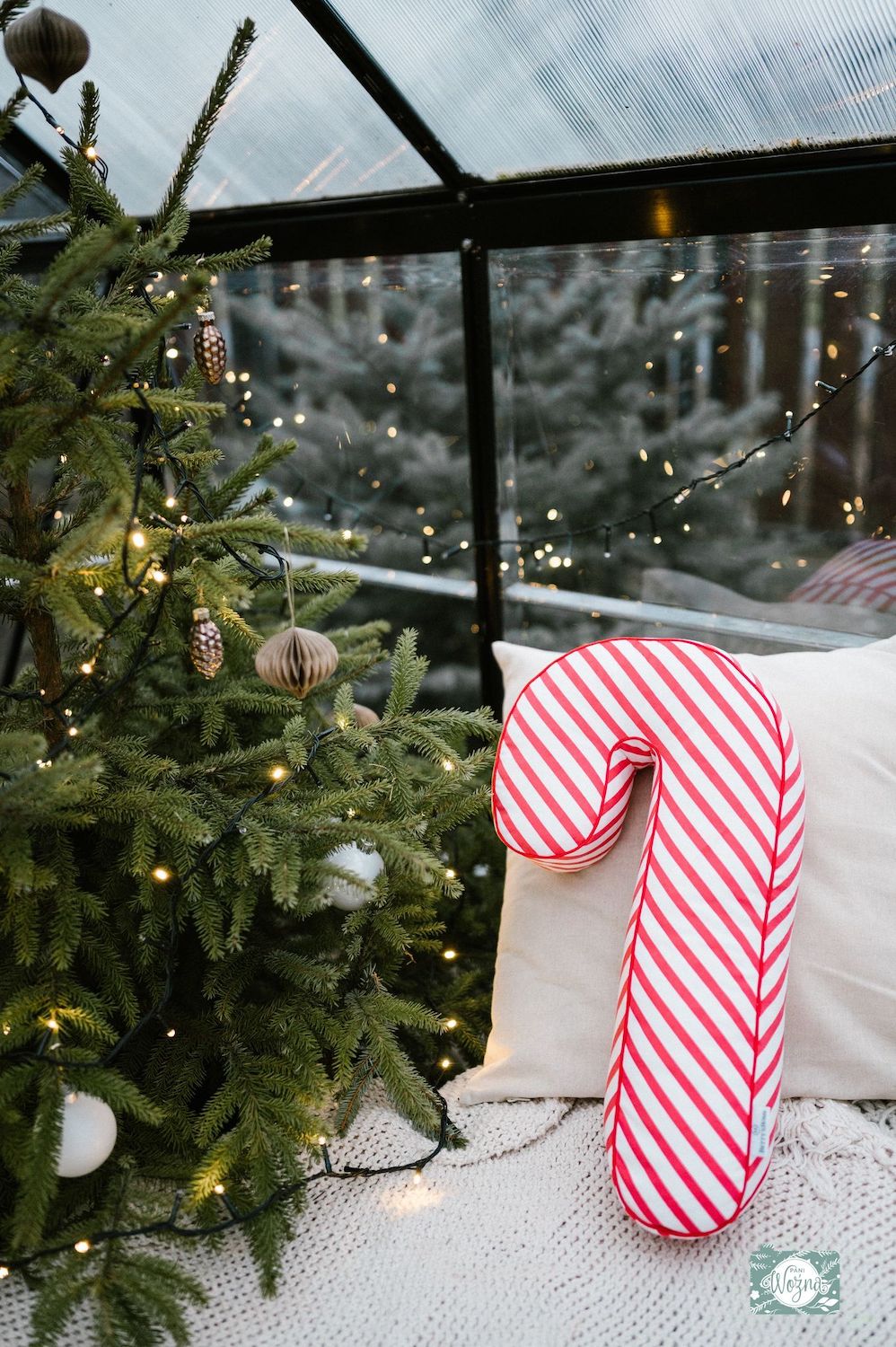 Christmas candy cane cushion red stripes by bettys home on chair next to christmas tree. Candy cane Pillow Candy