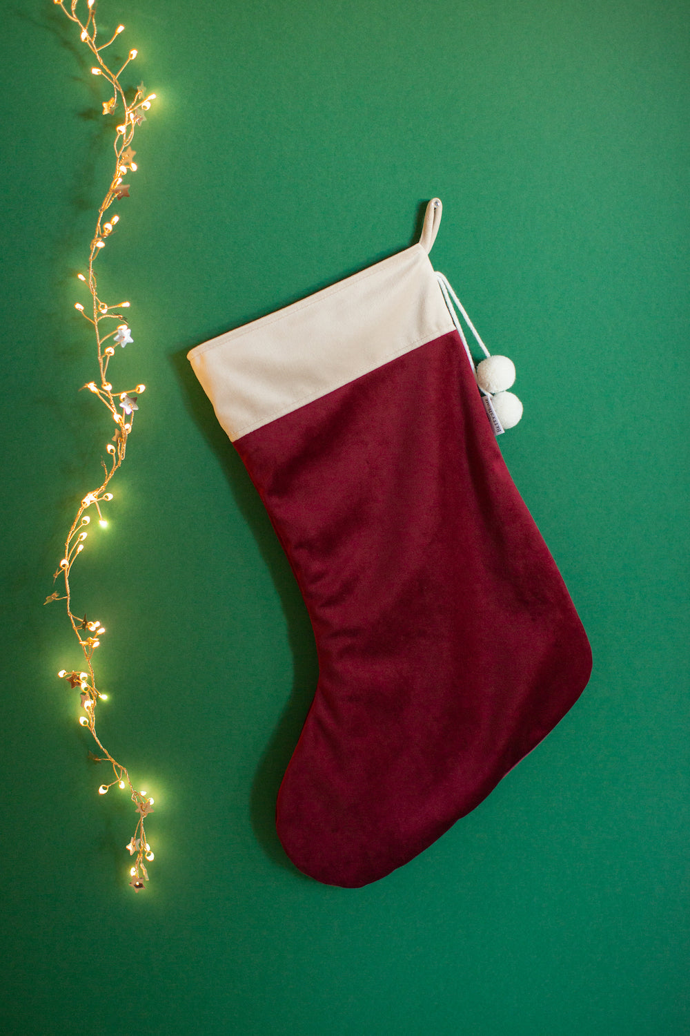 christmas stocking in wine red by bettys home hanging on green wall as christmas decoration for kids