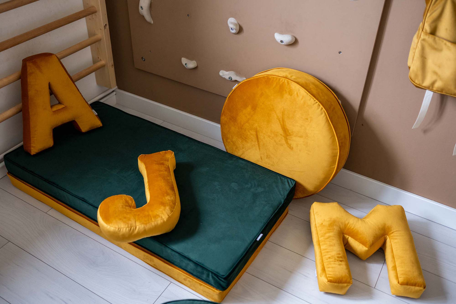 childrens gymnastic room with velvet mattress and large velvet pouf and velvet letter cushion by bettys home 