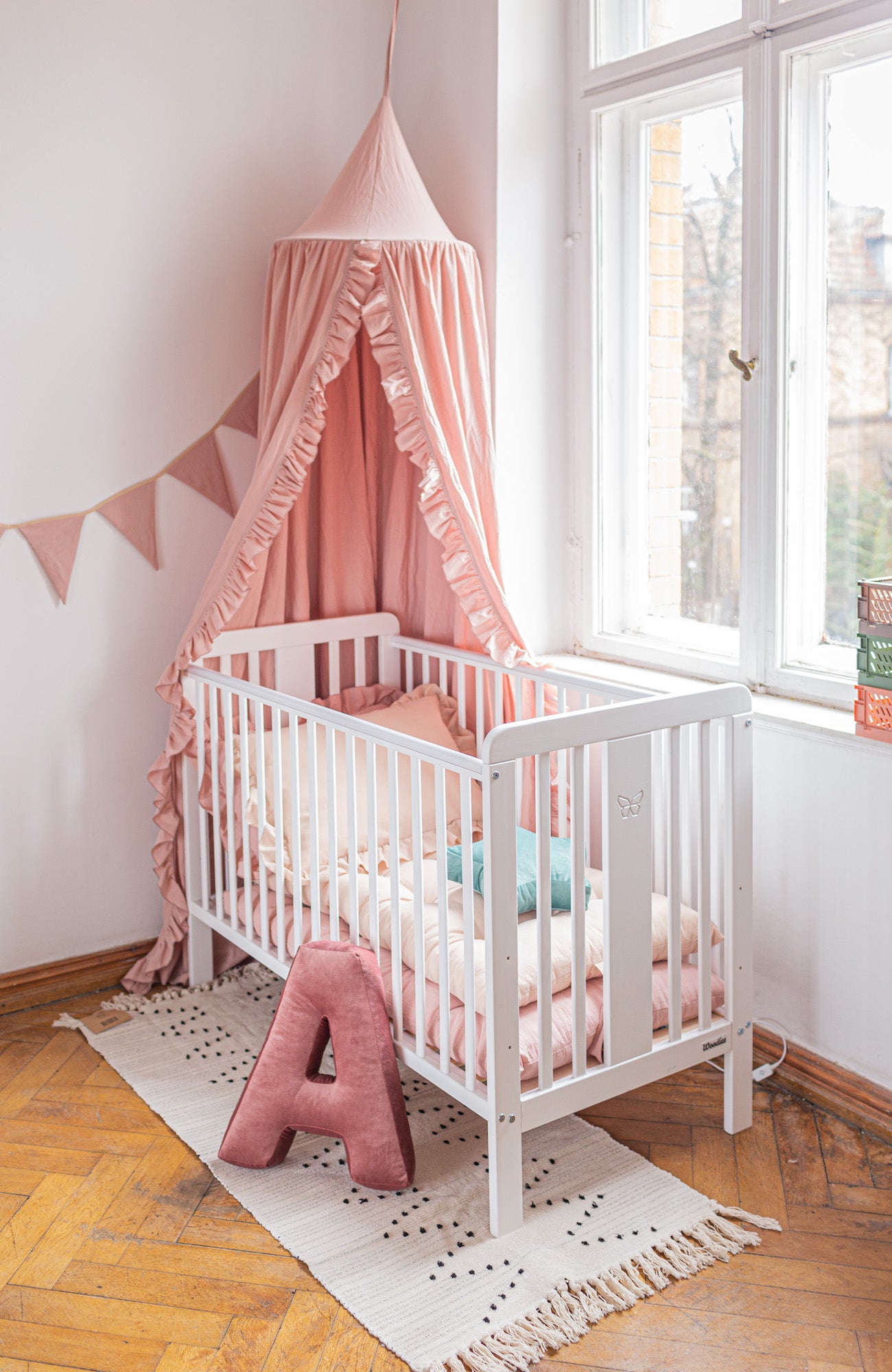kids bed corner with cotton canopy over the bed and velvet letter cushion a in pink by bettys home
