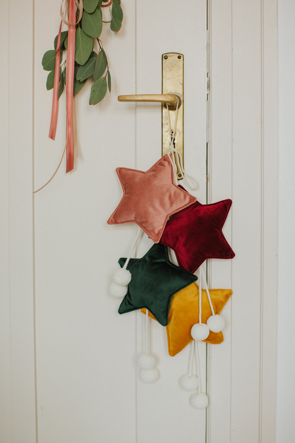 velvet little star pendant pink old rose with pompoms by bettys home hanging on door handle with other star pendants 