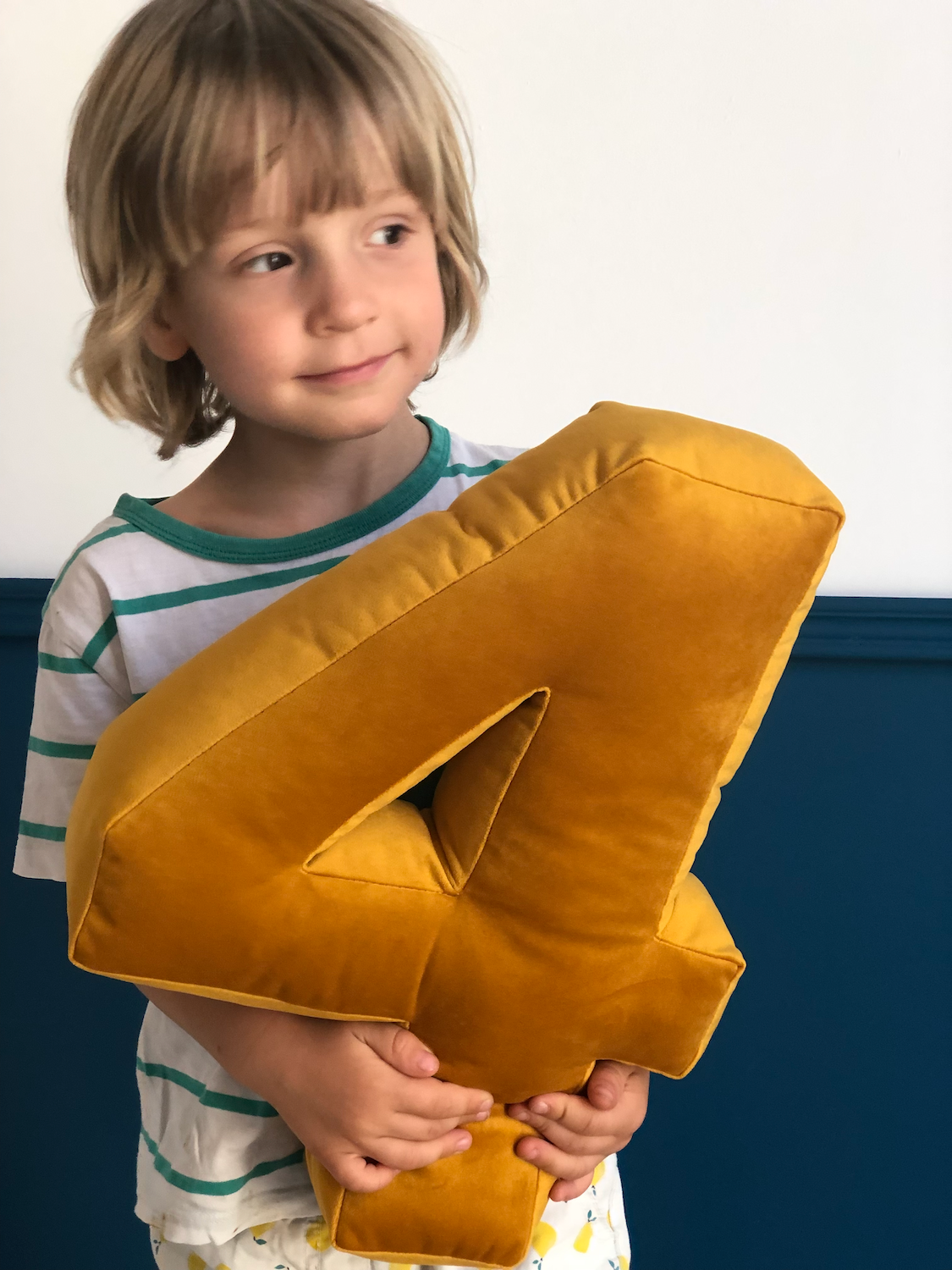 little boy holding velvet number 4 in yellow. birthday deco idea by bettys home