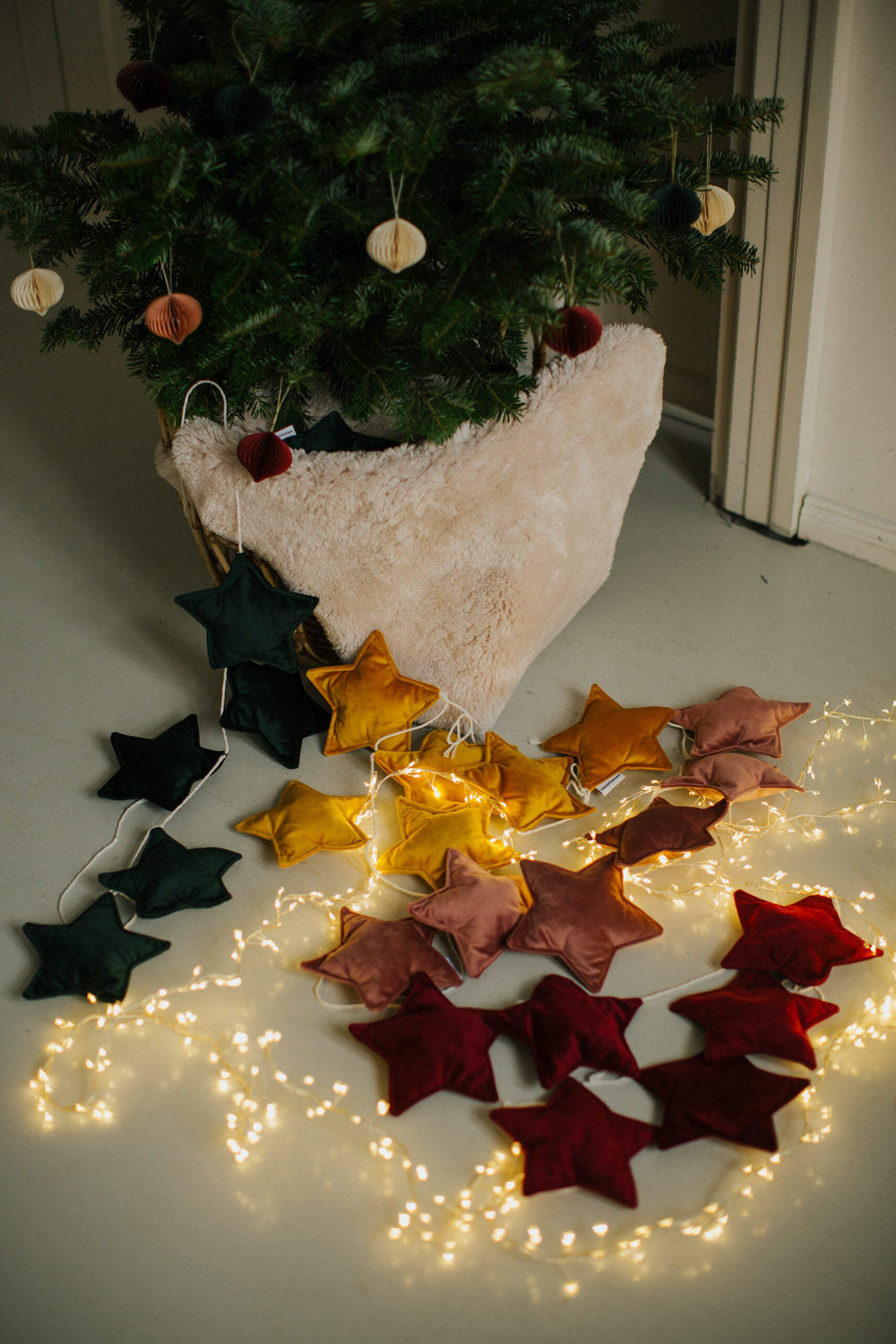 velvet star garland in pink old rose by bettys home among other star garlands next to christmas tree