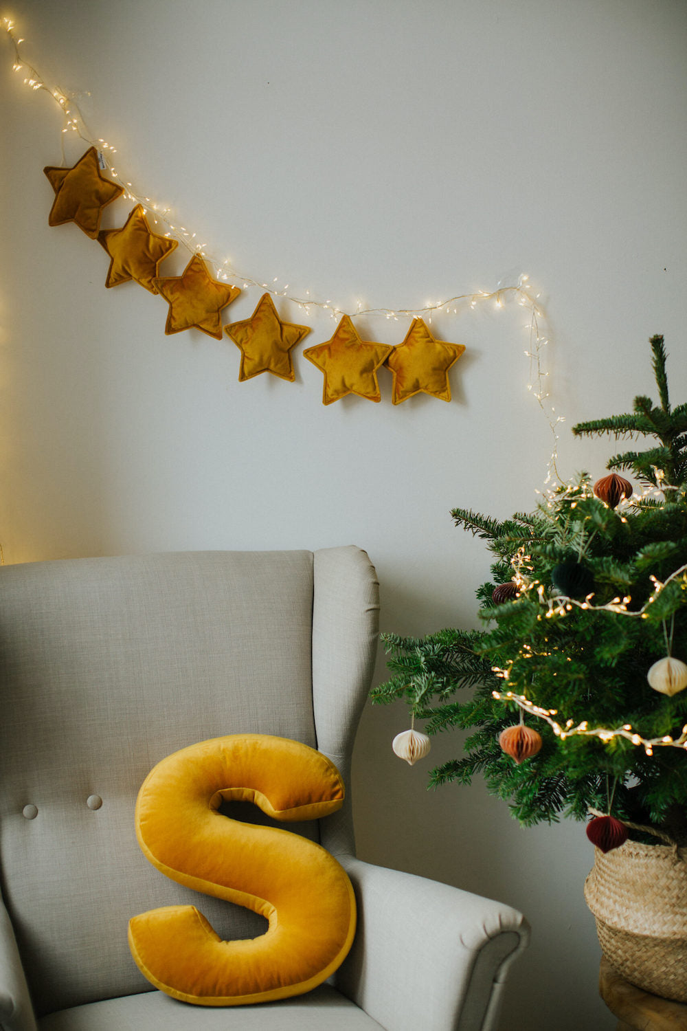 velvet star garland yellow by Bettys home over armchair with velvet letter star cushion by bettys home
