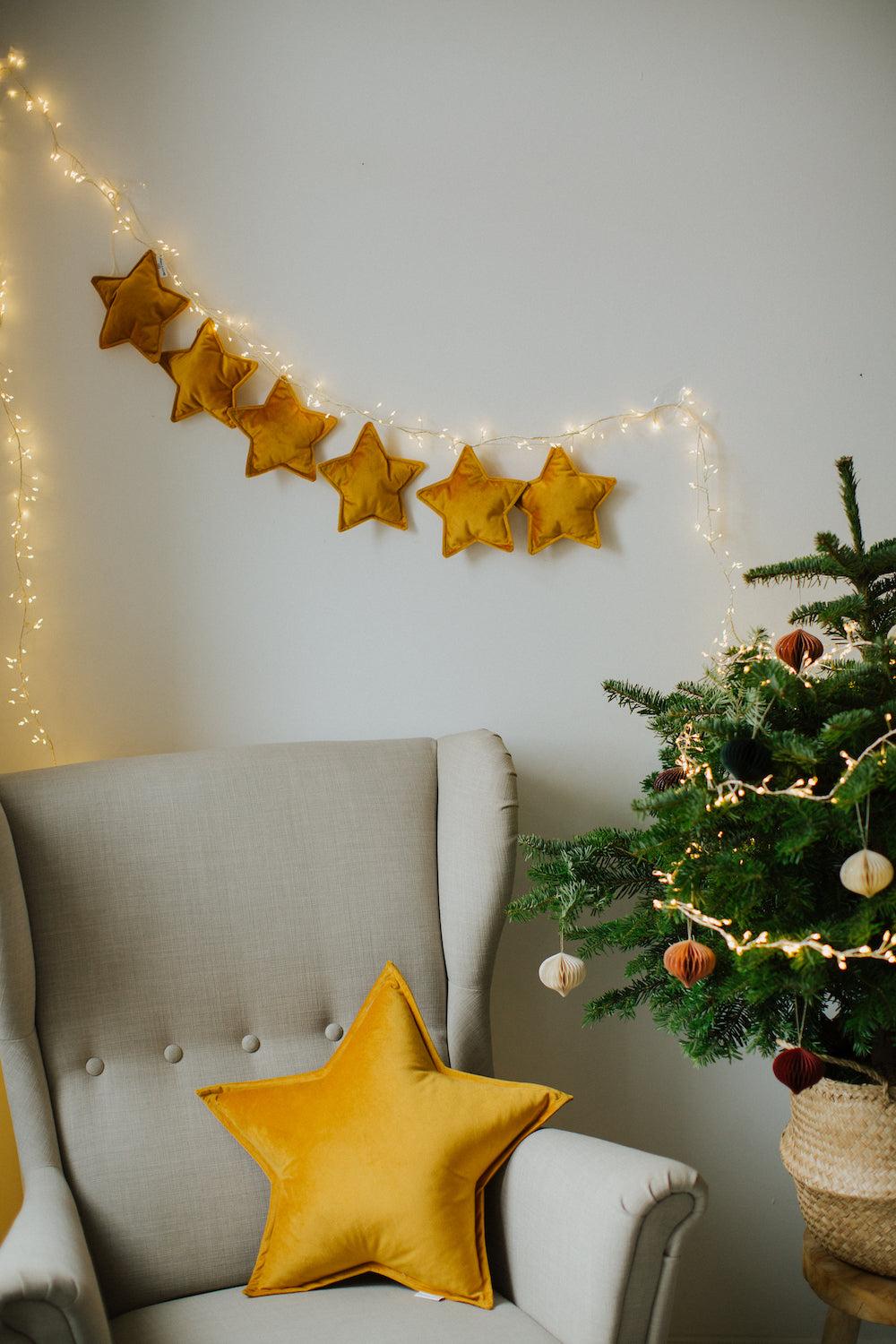 velvet star garland yellow by Bettys home over armchair with yellow star cushion next to christmas tree