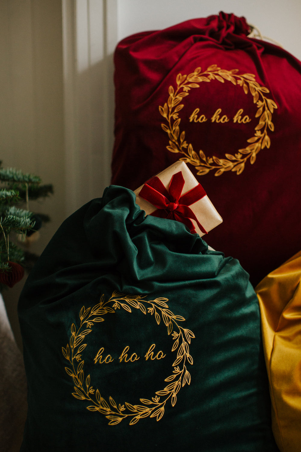 green and red christmas sacks full of gifts with embroidered ho ho ho by Bettys Home 