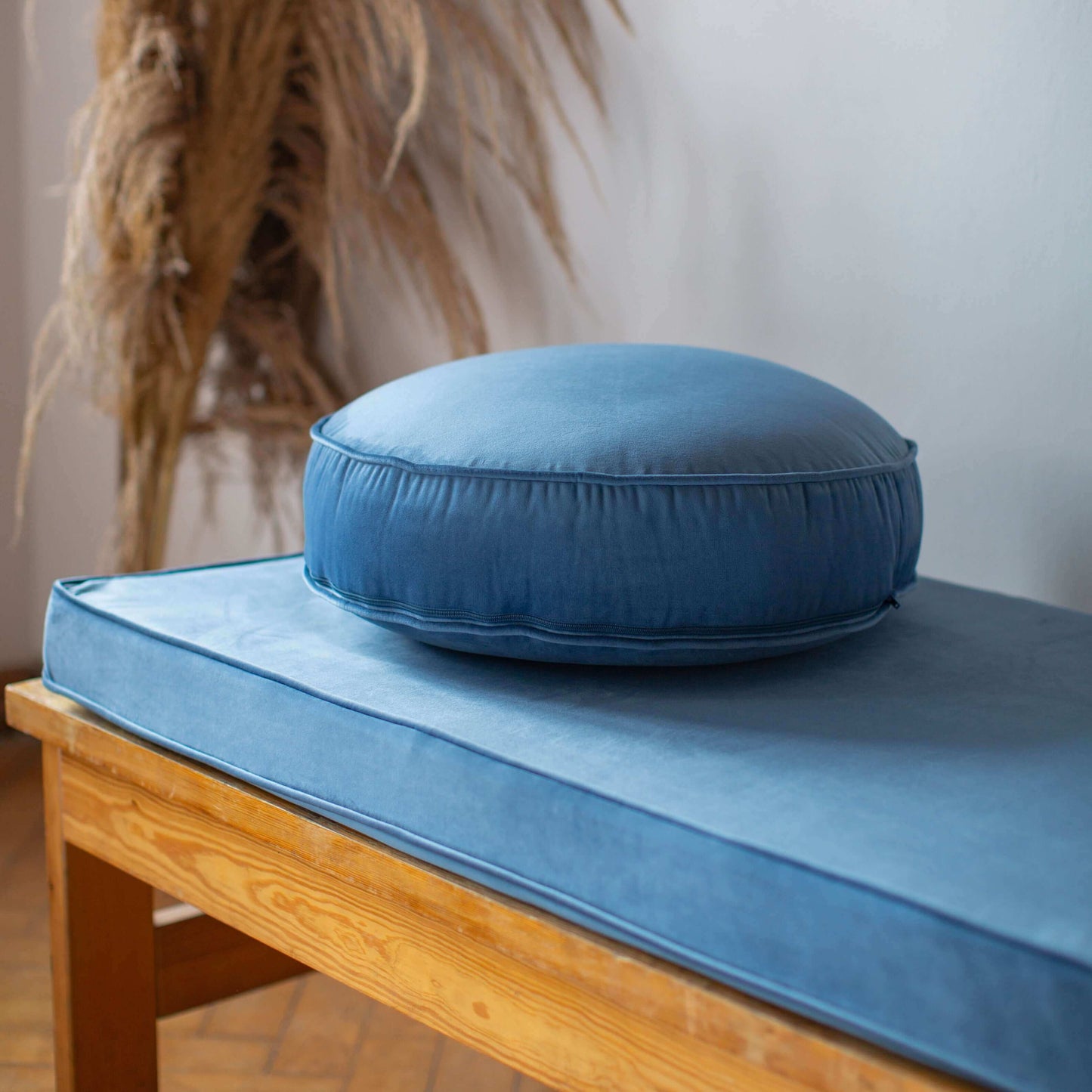 Small Velvet Pouf Blue on velvet blue mattress on bench